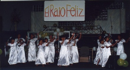 white_dress_dancers_with_sign.jpg