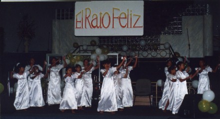 white_dress_dancers_with_sign.jpg